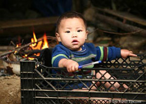 Baby boy sitting in a crate in Sapa Vietnam