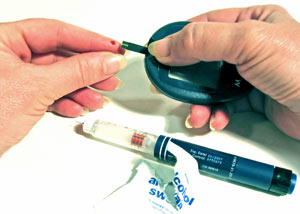 Diabetic person measuring her blood sugar levels