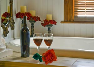 Two wine glasses in a romantic setting in bathroom
