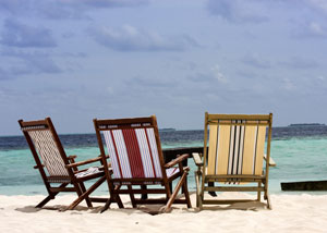 Three beach chairs on sunny beach