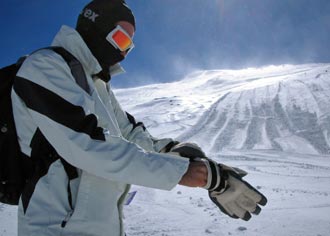 skier putting on his ski gloves