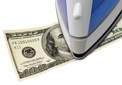 Tourist scams Iron on top of a 100 dollar bill