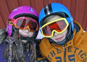 Two kids with ski helmets