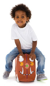 Young boy sitting on top of his children luggage