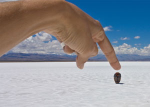Finger pointing at rock in a desert