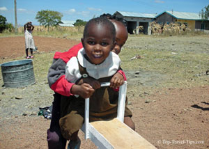 Two kids playing on a seesaw in Tanzania
