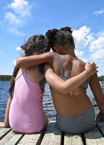 Two young girl holding arms